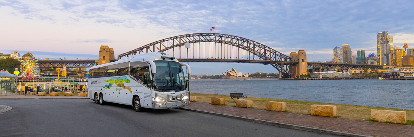 Greyhound bus in front of Sydney Harbour Bridge