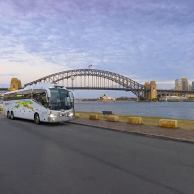 Greyhound bus in front of Sydney Harbour Bridge