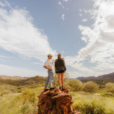 Couple on top of a rock column in the outback.