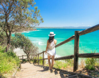 Photo of a young lady descending beach stairs.