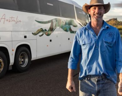 Greyhound customer standing with Greyhound coach.
