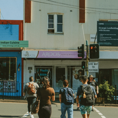 Group of friends cross the road in Sydney suburb.